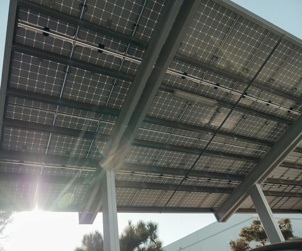 Dark carbon texture with golden light rays representing energy